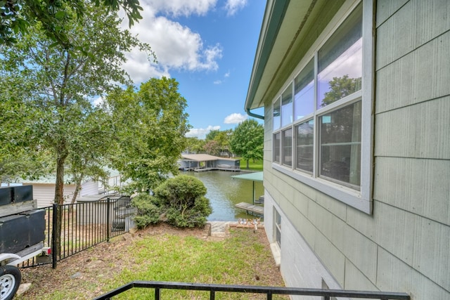 view of yard featuring a water view and fence