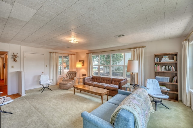 carpeted living area with plenty of natural light and visible vents