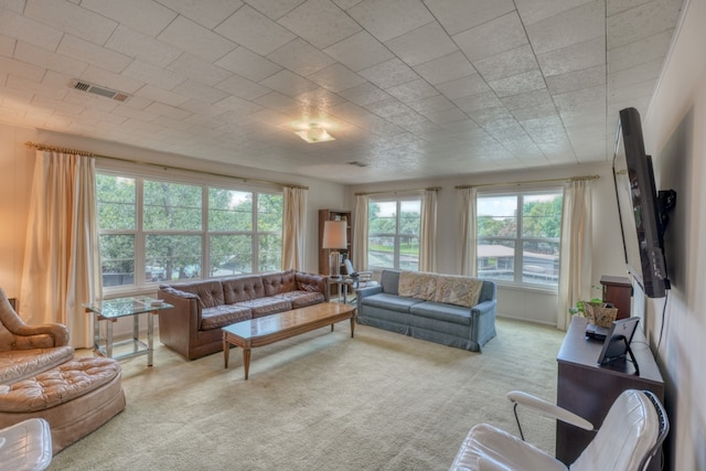 carpeted living area featuring visible vents