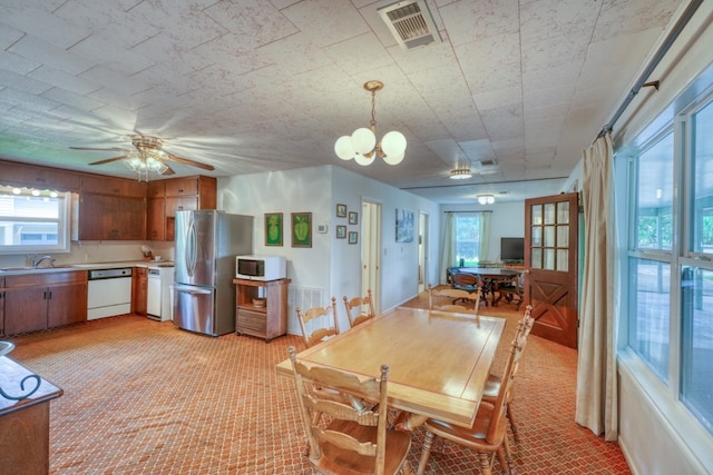 dining area with visible vents and ceiling fan with notable chandelier