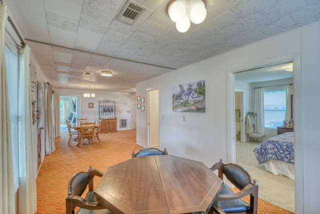 dining room featuring light carpet and visible vents