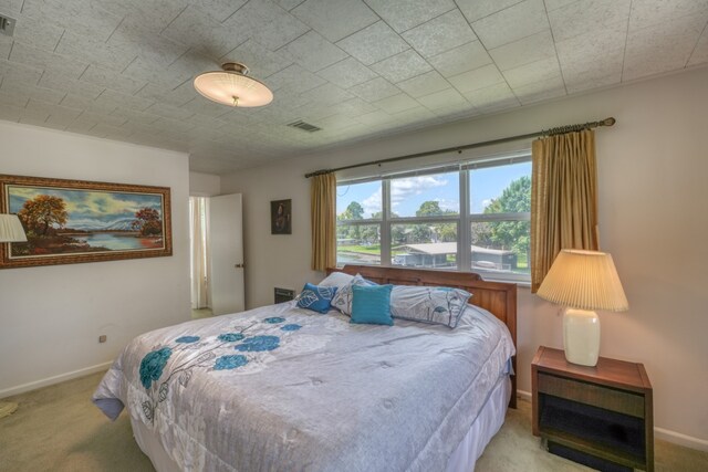 bedroom with baseboards, visible vents, and carpet floors