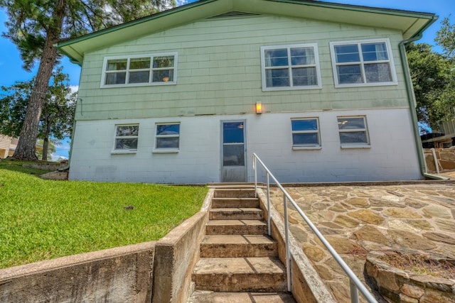 back of house with a lawn