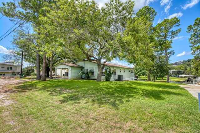 exterior space with a front yard and cooling unit