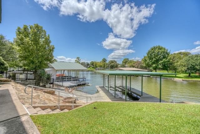 view of dock with a yard, a water view, and boat lift