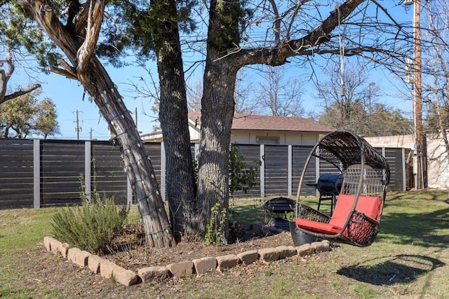 view of side of property featuring an outbuilding, a lawn, and fence