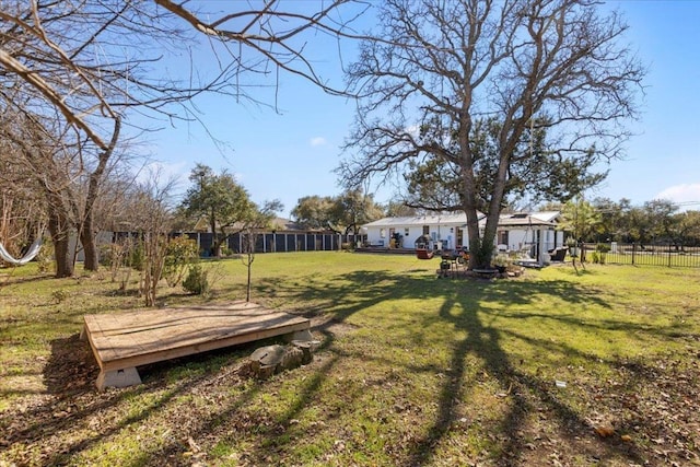 view of yard featuring a deck and fence