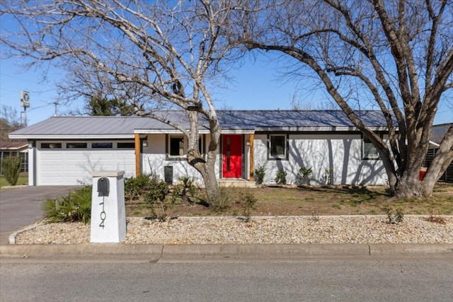 single story home with an attached garage and driveway