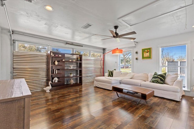 living room featuring recessed lighting, visible vents, attic access, and wood finished floors