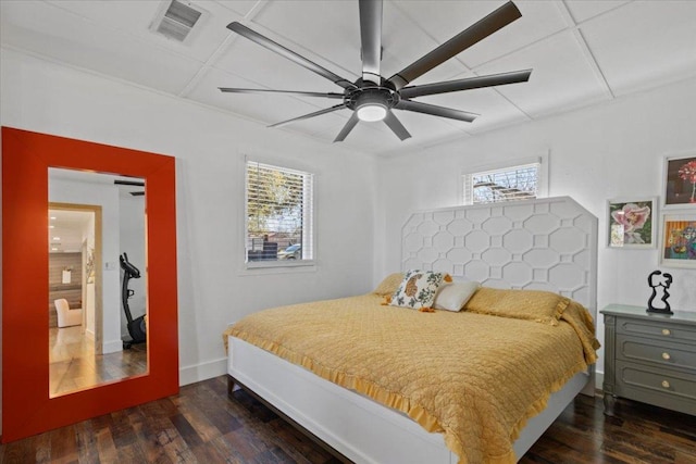 bedroom featuring visible vents, baseboards, wood finished floors, and a ceiling fan