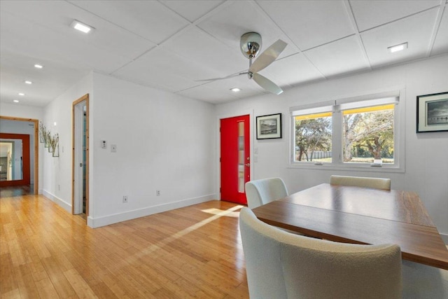 unfurnished dining area with light wood-style flooring, recessed lighting, a ceiling fan, and baseboards