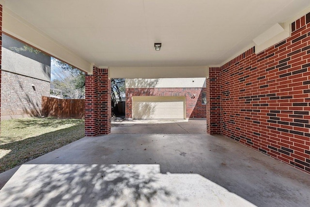 view of patio / terrace featuring driveway and fence