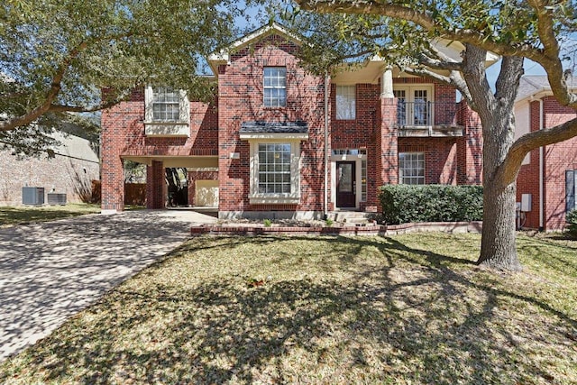 view of front of property with a balcony, cooling unit, a front lawn, decorative driveway, and brick siding