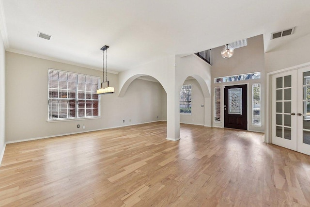 foyer entrance with light wood-style floors, french doors, visible vents, and baseboards