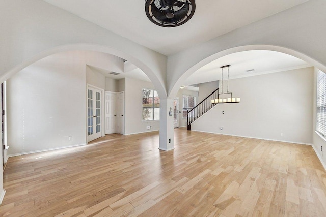 interior space featuring visible vents, stairs, light wood-type flooring, and baseboards