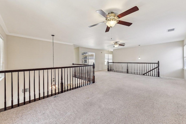 corridor featuring visible vents, carpet flooring, and crown molding