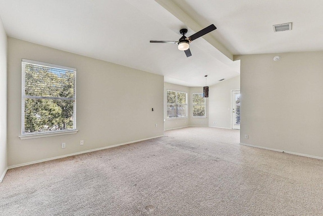 carpeted spare room featuring baseboards, visible vents, a ceiling fan, and lofted ceiling