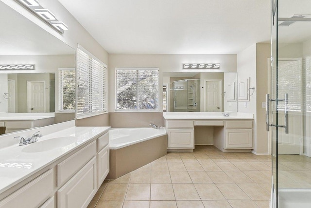 full bath with a garden tub, two vanities, a sink, a shower stall, and tile patterned flooring