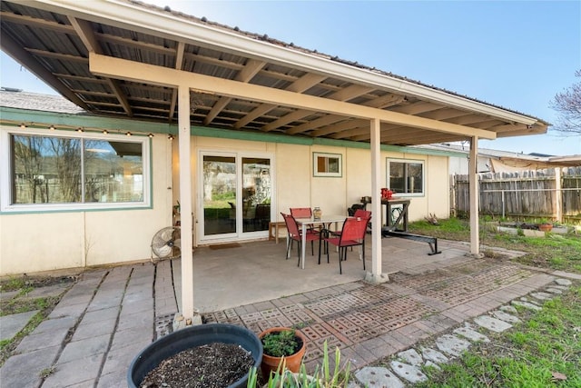 view of patio with outdoor dining area and fence