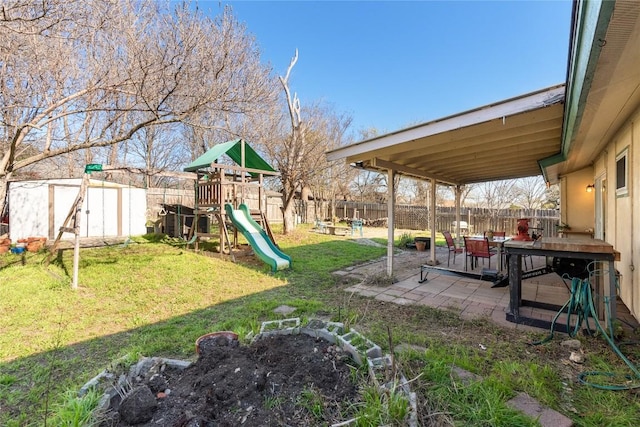 view of yard with a playground, a patio area, and a fenced backyard