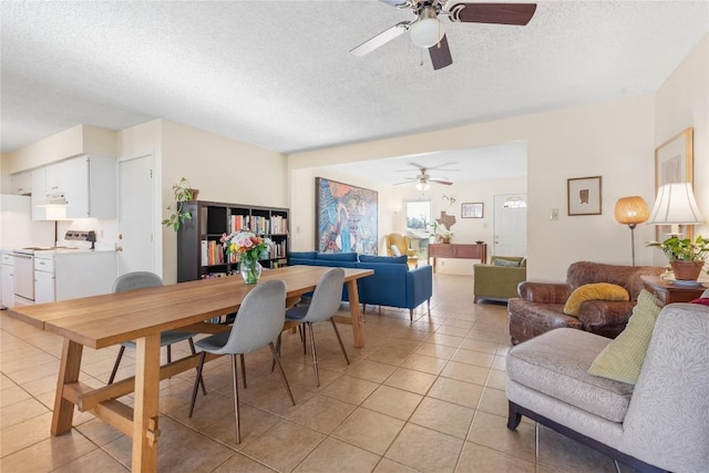 dining area featuring light tile patterned flooring, a textured ceiling, and a ceiling fan