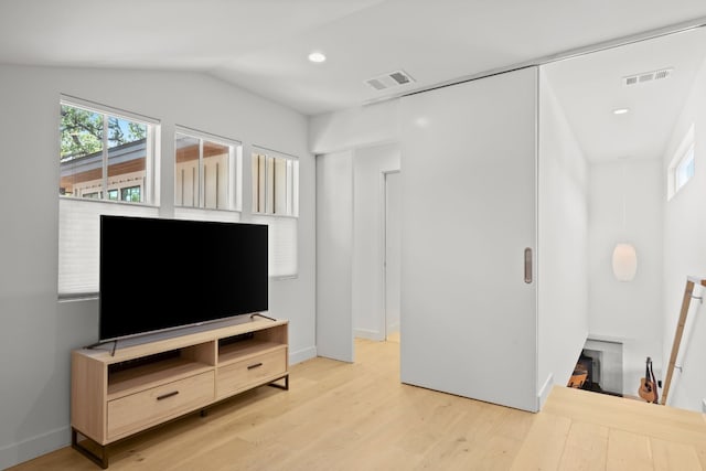 living area featuring visible vents, recessed lighting, light wood-type flooring, and lofted ceiling