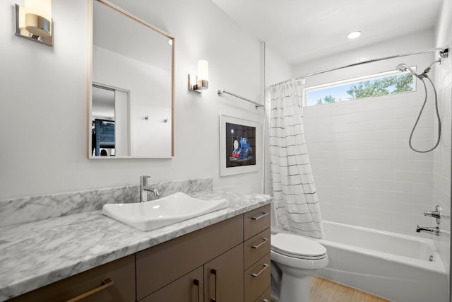full bathroom featuring recessed lighting, wood finished floors, toilet, vanity, and shower / tub combo
