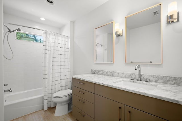 bathroom featuring wood finished floors, vanity, shower / bathtub combination with curtain, toilet, and visible vents