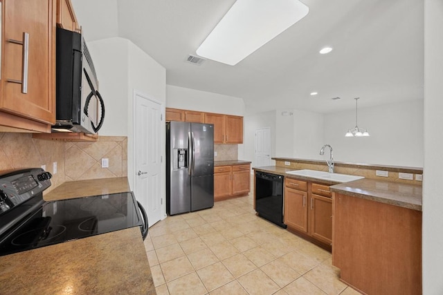 kitchen featuring visible vents, backsplash, pendant lighting, black appliances, and a sink