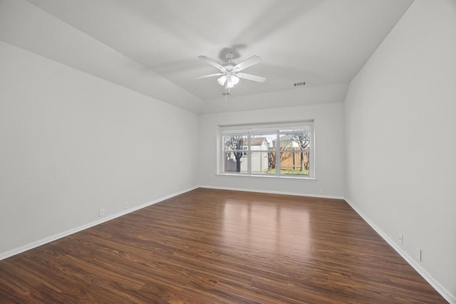 empty room featuring a ceiling fan, visible vents, baseboards, and dark wood-style flooring