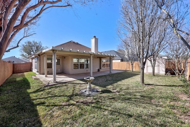 back of house with a patio, a fenced backyard, an outdoor structure, and a chimney