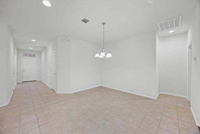 unfurnished room with a notable chandelier, visible vents, and light tile patterned floors