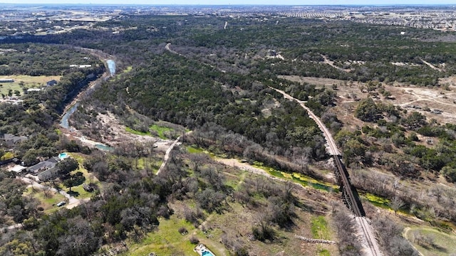 birds eye view of property featuring a forest view