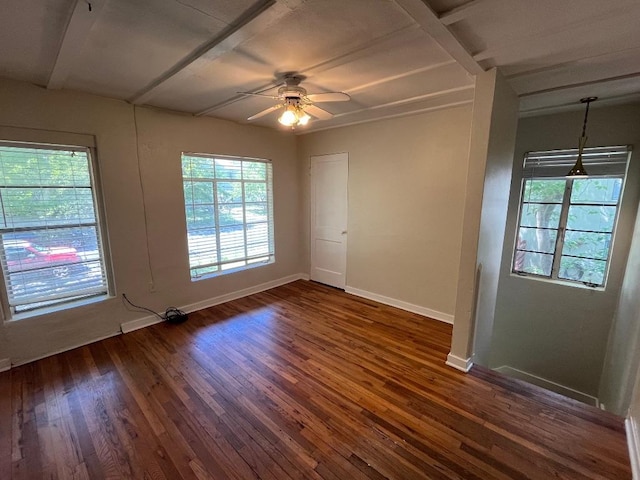 unfurnished room featuring ceiling fan, dark wood-type flooring, and baseboards