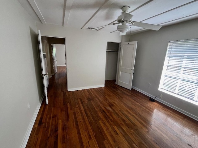 unfurnished bedroom with a closet, baseboards, wood finished floors, and a ceiling fan