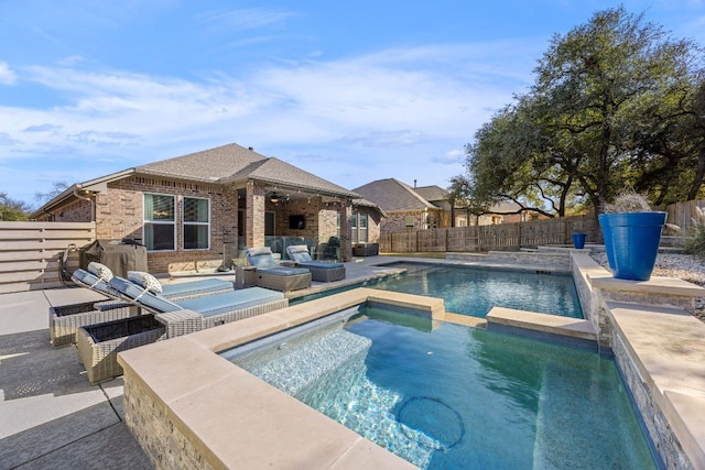 view of pool featuring ceiling fan, a patio, a fenced backyard, and a pool with connected hot tub