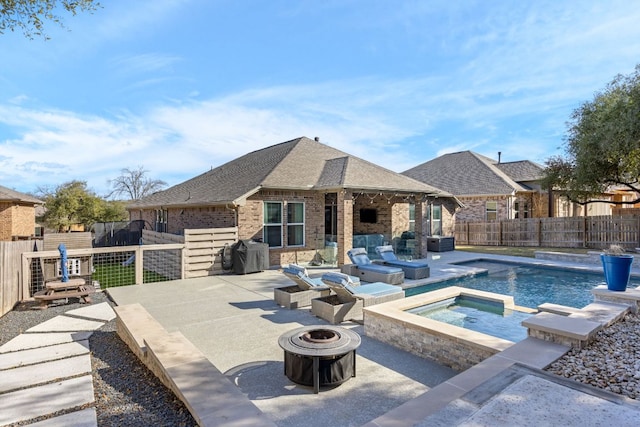view of pool with a fire pit, an in-ground hot tub, a patio area, and a fenced backyard