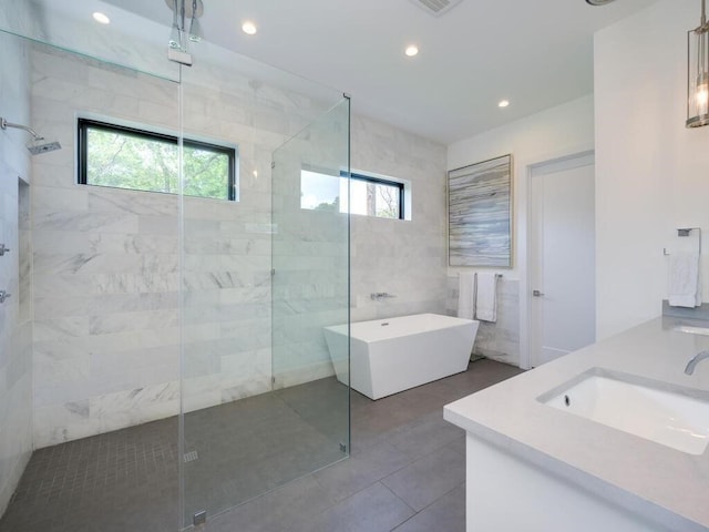 bathroom featuring a sink, a soaking tub, recessed lighting, and a shower stall