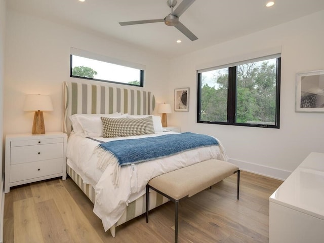 bedroom with a ceiling fan, recessed lighting, light wood-type flooring, and baseboards