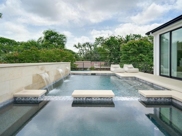 view of pool with a pool with connected hot tub