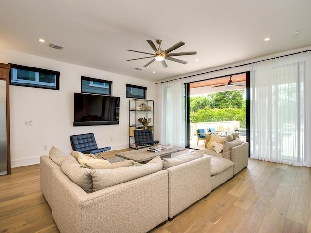 living room with visible vents, baseboards, ceiling fan, recessed lighting, and light wood-style floors