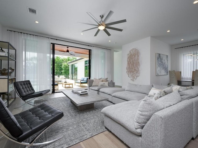 living area with a ceiling fan, recessed lighting, wood finished floors, and visible vents