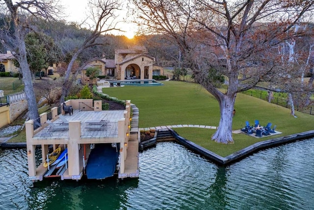 dock area with a yard and a water view