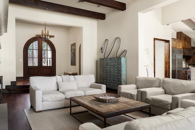 living area featuring dark wood-type flooring, french doors, beamed ceiling, and an inviting chandelier