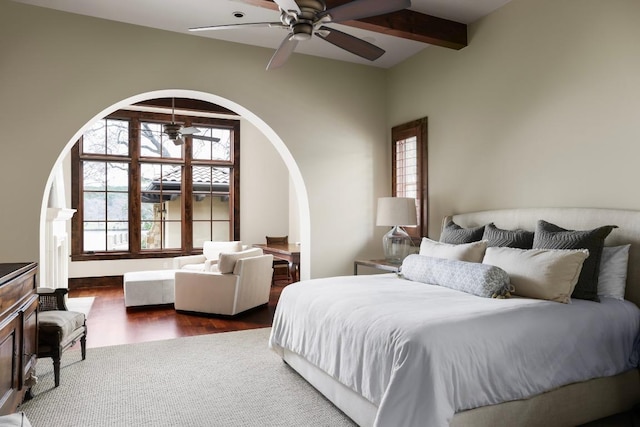 bedroom featuring arched walkways and dark wood-style floors