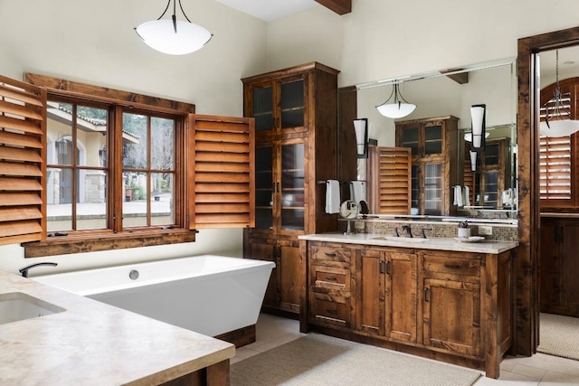 full bathroom with tile patterned flooring, a soaking tub, and vanity