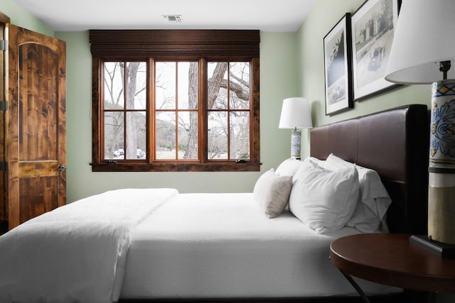 bedroom featuring multiple windows and visible vents