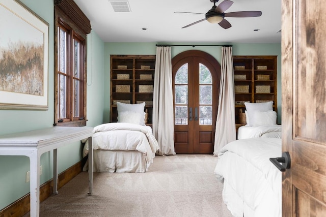 carpeted bedroom with french doors, visible vents, and a ceiling fan