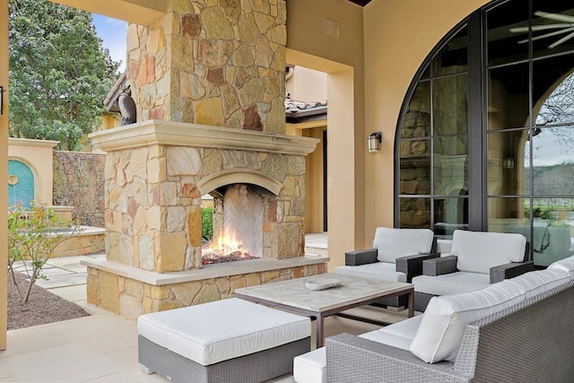 view of patio / terrace with an outdoor living space with a fireplace