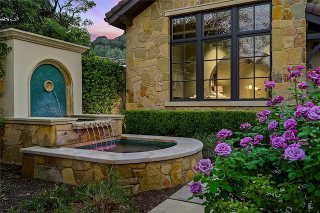 view of exterior entry featuring stone siding